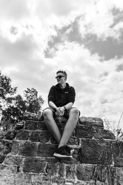 man sitting on top of some bricks Candid photography tips and examples